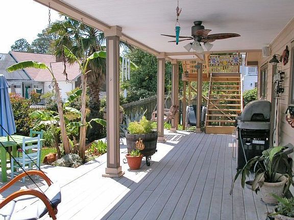 Covered porch off of great room and kitchen overlooking pool