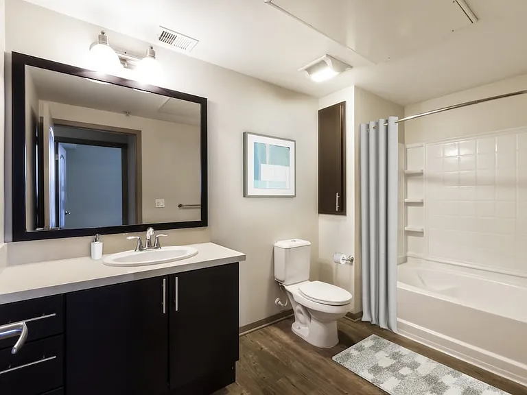 Classic Collection bath with beige quartz countertops, espresso cabinetry, and hard surface flooring