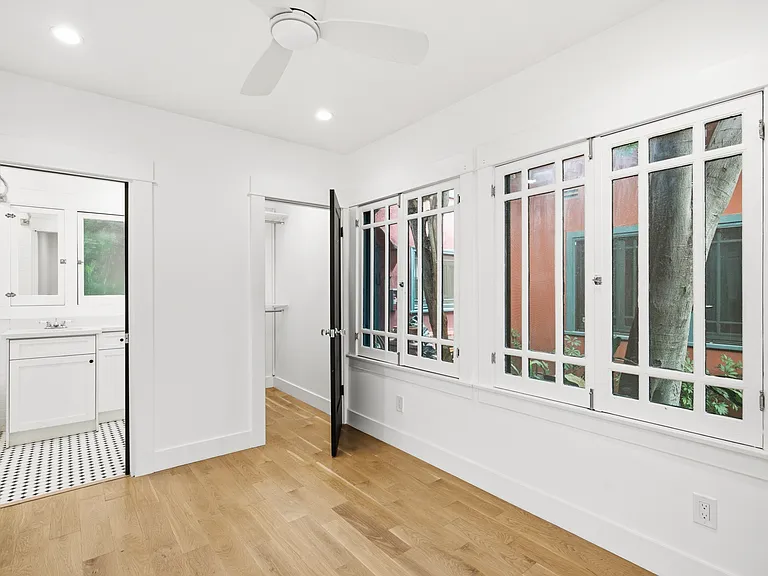 View of the bedroom and the entrances to the closet and bathroom.