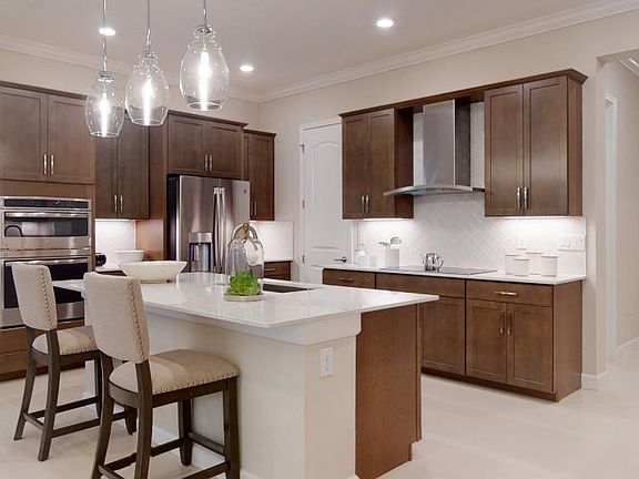 Situated among the home s open design, the contemporary kitchen with a versatile center island and p