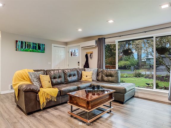 Warm & cozy Family Room features oversized windows to let in that coveted natural light and a Dustless mini-split to keep you cool in those hot summer days.
