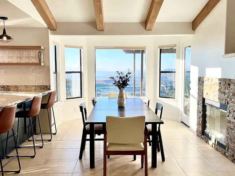 Open layout floor plan opens up to a central dining space upon entry with sweeping views of the mountains and lake