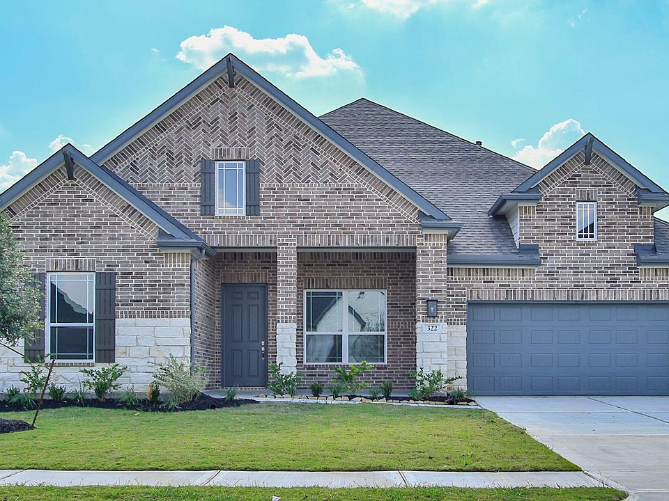 Stunning brick facade with intricate stone detailing enhances this Brookewater residence s timeless