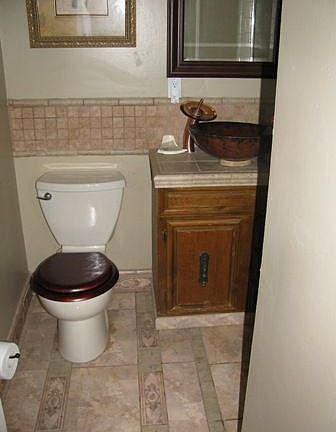 Beautiful amber vessel sink with decorative tile flooring in master bathroom