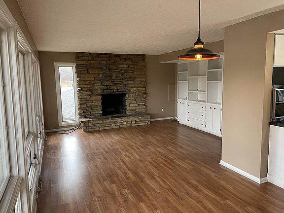 living and dinning room with a kitchen to the right and deck to the left with panoramic water views from every room