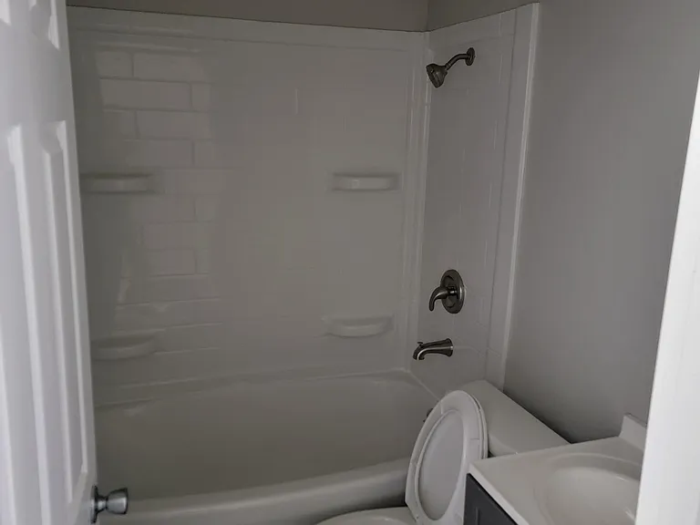 Huge soaking tub with beautiful surround and New vanity, toilet and finishes