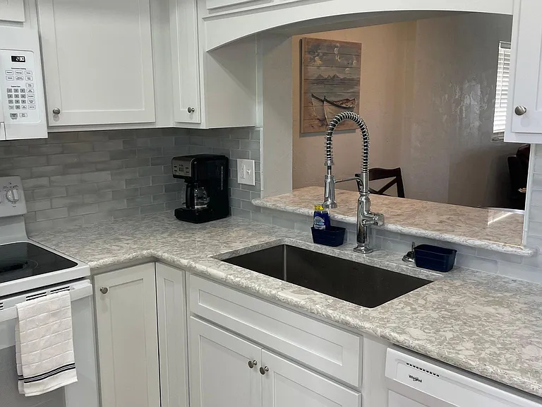 Kitchen with view through living to lake