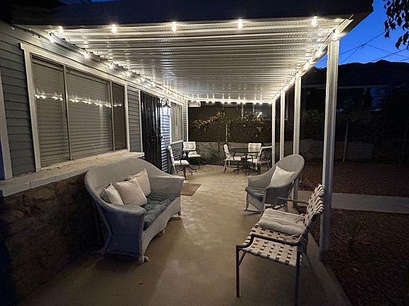 Covered front patio area with dimmable string lites