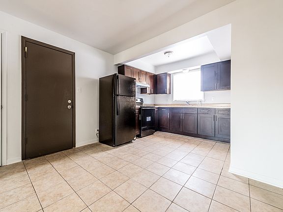 This kitchen at 1121 W 127th St features updated cabinetry and appliances!