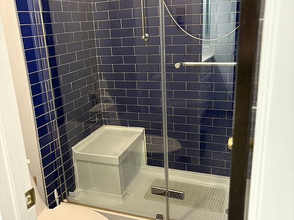 Gorgeous subway tile from floor to ceiling with state of the art shower.