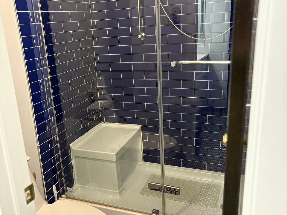 Gorgeous subway tile from floor to ceiling with state of the art shower.