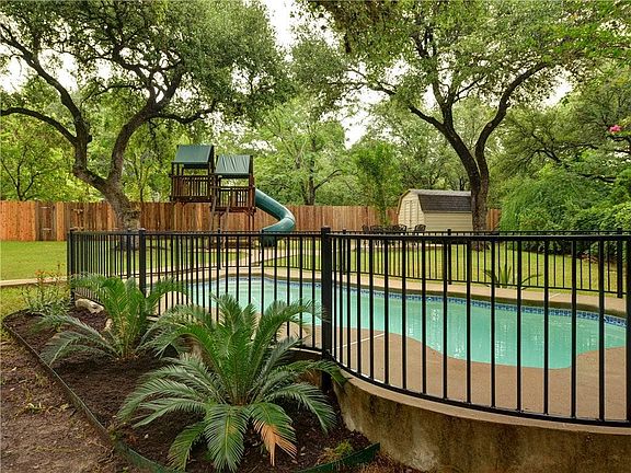 large shaded backyard with pool