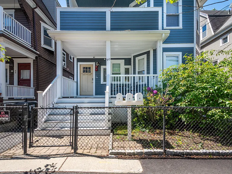 Fenced front door with camara, mailboxes accessible from sidewalk