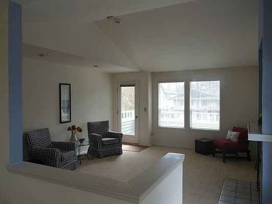 Large living room with vaulted ceiling, firplace and south facing lanai.