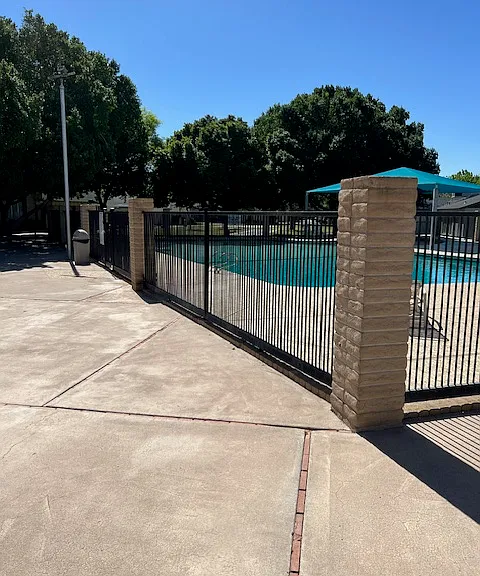 Eastwood Townhomes Large Gated Swimming Pool with Shaded Child Shallow Area, Sun Lounge Area.