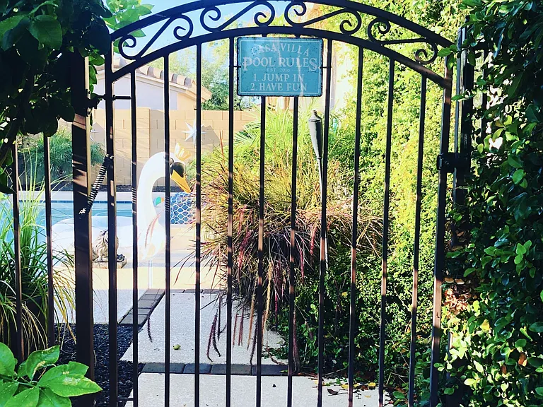 Security gate surrounds heated salt water pool