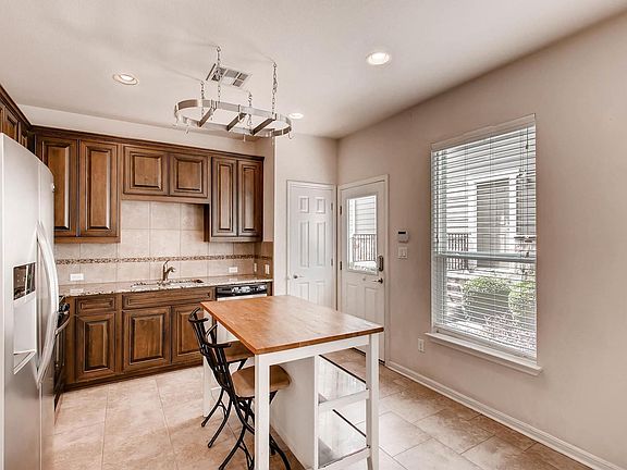 Kitchen island with a pot rack on the ceiling for modern dec