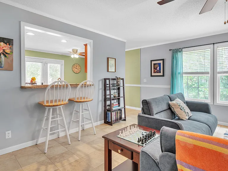 Kitchen overlooks the living room, with counter seating.
