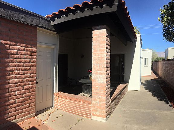 Entry walk-way past the door to garage, master bedroom 1 and past the kitchen and shaded, outdoor breakfast nook.