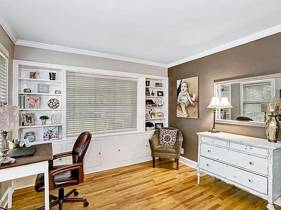 Living room has beautiful built-in book shelves and storage.