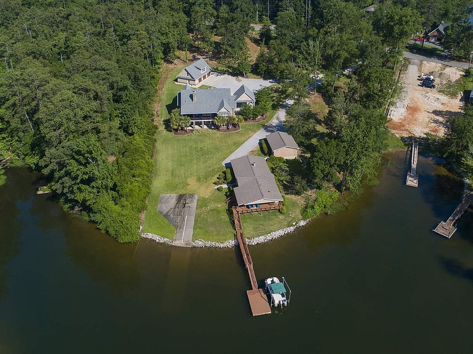 Image 1: 3 car garage in front, 2 car garage in front of guest home, 2 car port attached to main house