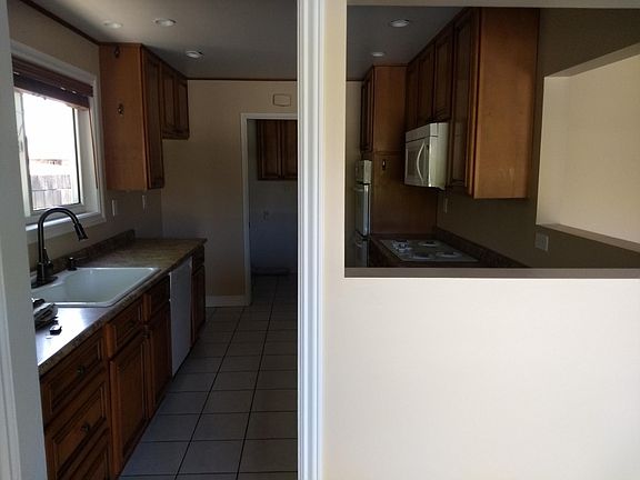 Tons of cabinetry storage with laundry room accessible through kitchen.