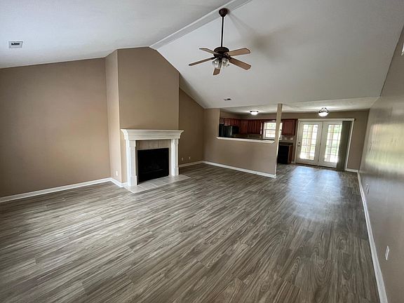 The kitchen and living room has a open floor plan. The 32' by 18' living room has a vaulted ceiling and laminate hardwood floors.