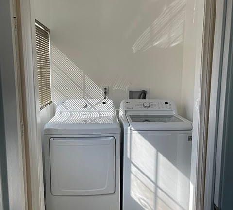 small wash room with new LG washer and dryer