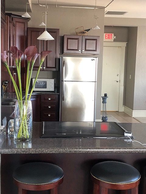 Cherry kitchen cabinets with wine storage.