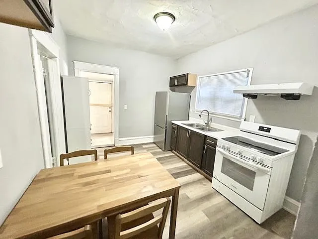 Efficient kitchen with full appliance suite, ample counter space, and a dining nook for everyday meals.