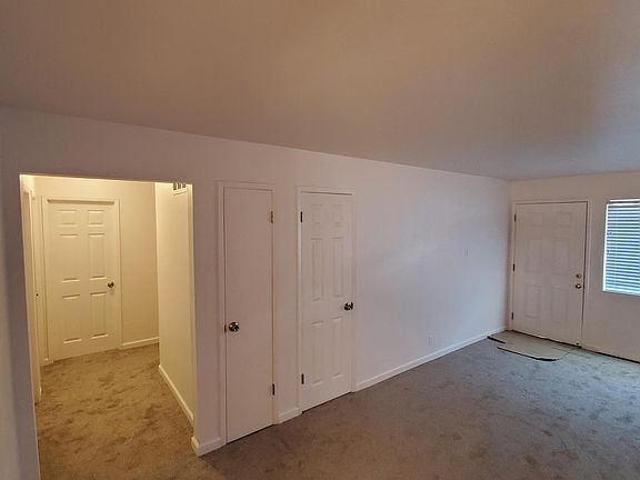 Side shot o living room and coat closet.