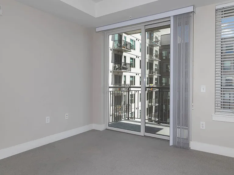 Carpeted Bedroom with Balcony