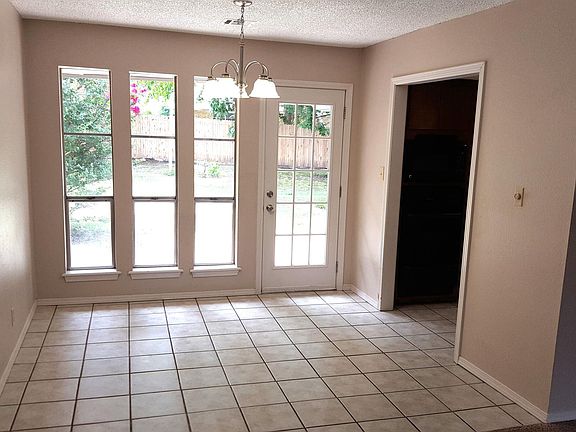 SUNNY PATIO EATING AREA WITH KITCHEN ON THE RIGHT. VIEWED FROM LIVING ROOM.