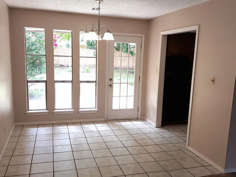 SUNNY PATIO EATING AREA WITH KITCHEN ON THE RIGHT. VIEWED FROM LIVING ROOM.