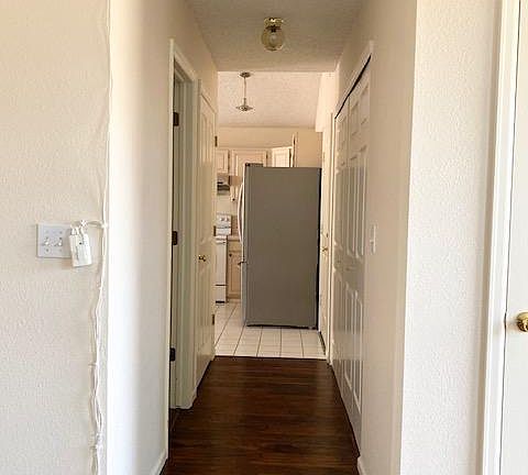 hall between living room and kitchen. laundry area is on the right
