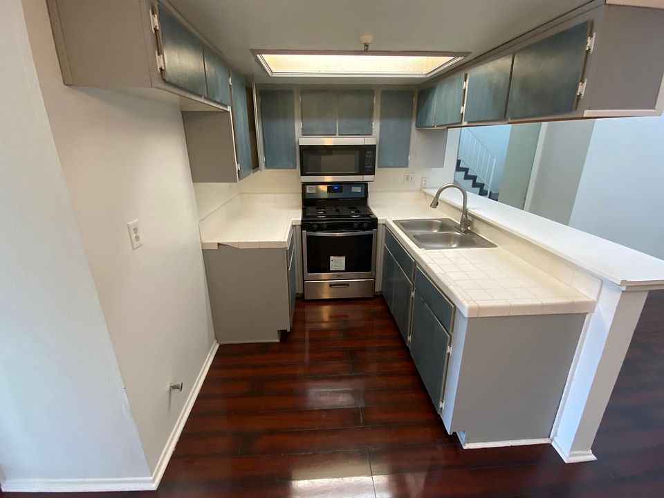 Kitchen comes with stainless steel microwave and stove