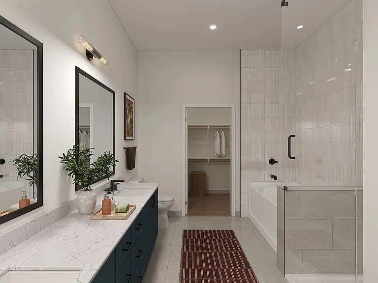 Apartment bathrooms with full-tile showers, tubs and dual vanities