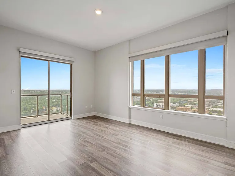 Relax in a spacious living room filled with natural light, with seamless access to your private balcony.