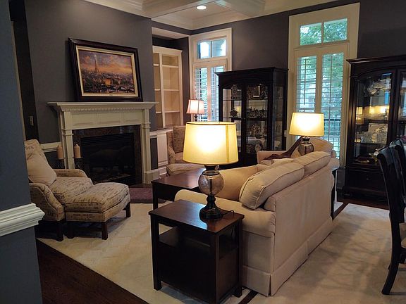 Formal living area with gas fireplace and built-in shelving.