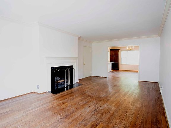 Large living room leading into open-concept dining room and kitchen