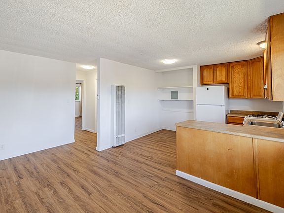 Open-concept living area with built-in shelving, and a functional kitchen for everyday comfort.