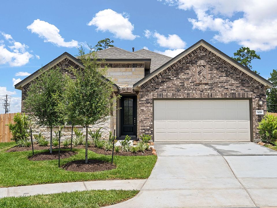 Welcome home to 3496 Acacia Grove Ln located in the Meadows at Imperial Oaks and zoned to Conroe ISD