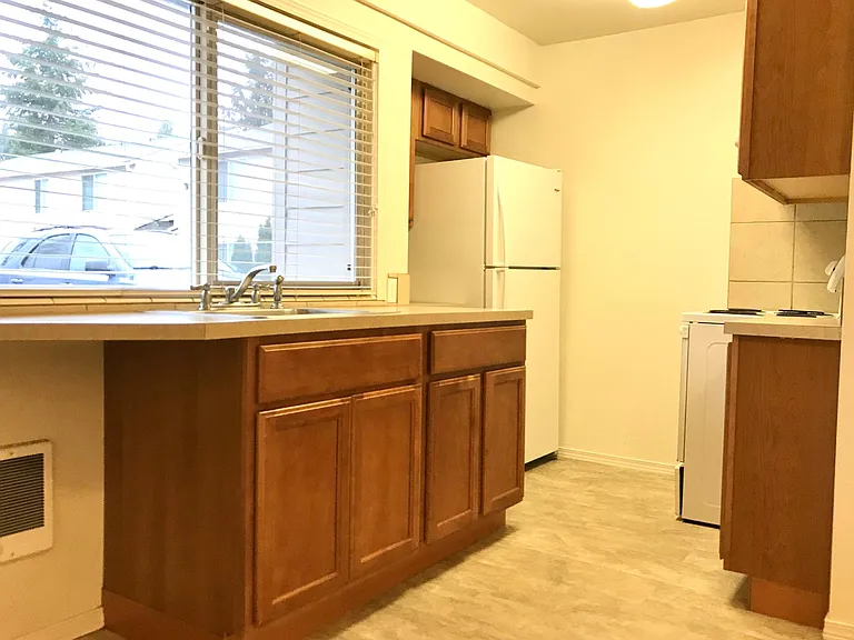 Sunny kitchen with nice cabinets.