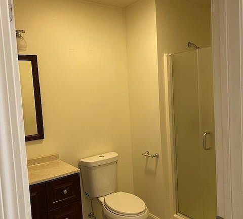 Bathroom with 5' shower, heavy glass shower doors, Porcelain tile floor.