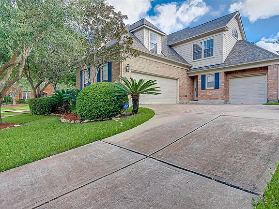 A DOUBLE AND SINGLE GARAGE ARE TUCKED AWAY ON THE SIDE OF THE HOME.