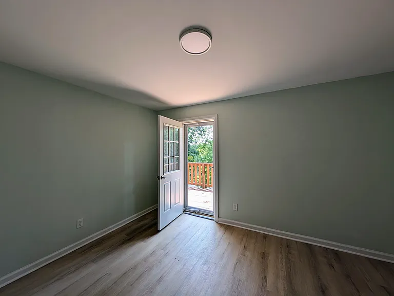 Middle bedroom looking toward door to second story deck