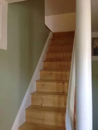 Stairs to bedrooms. Walls are now painted white.