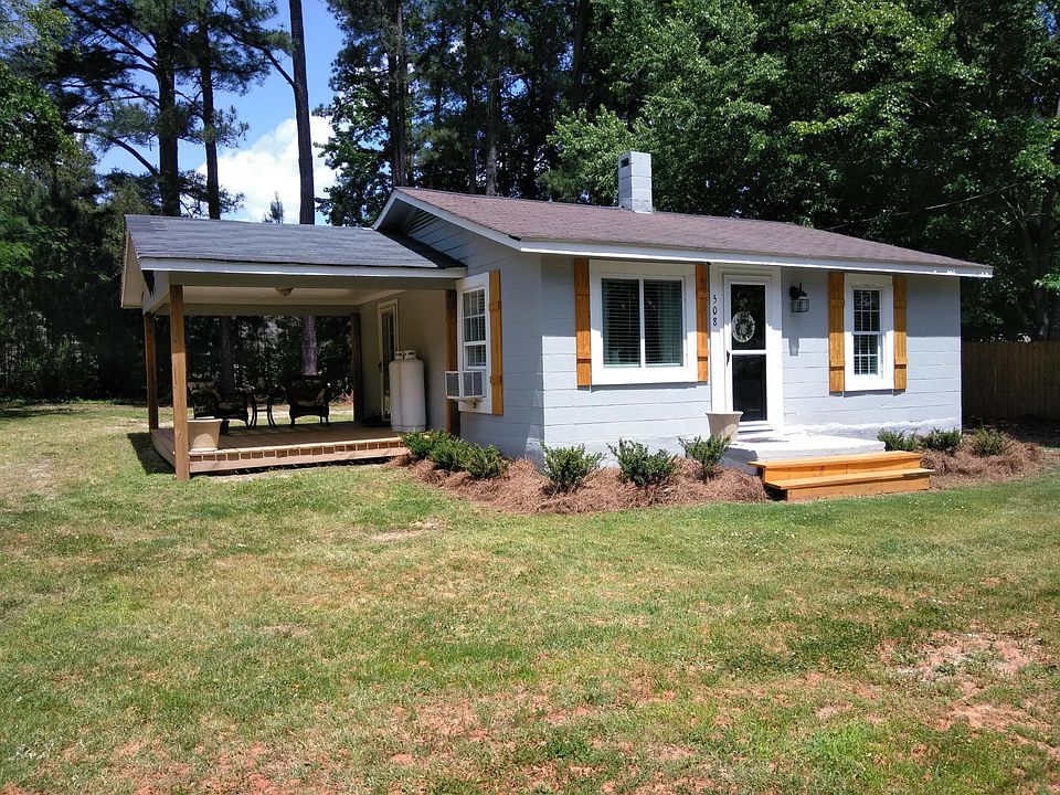 Front of home from street, notice large covered porch with side entry door. Typically parking in rear to side entry door.