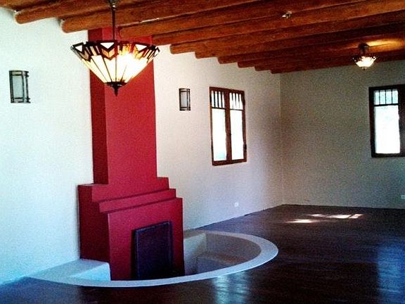 Living room with Sunken Wood Burning Fireplace.