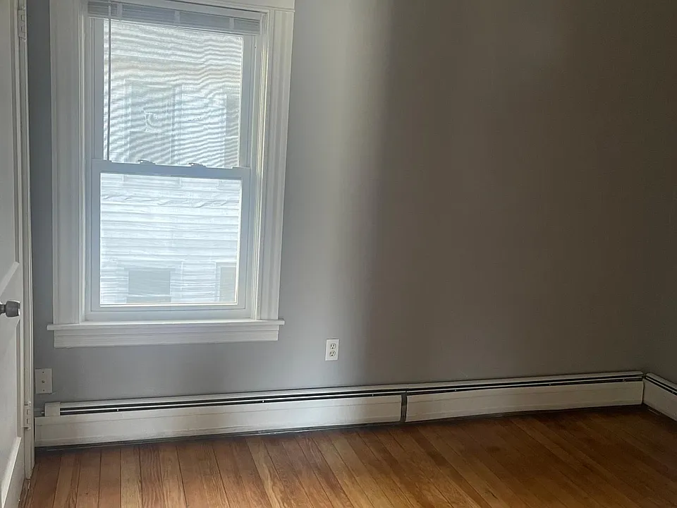 Freshly painted bedroom with refinished floors